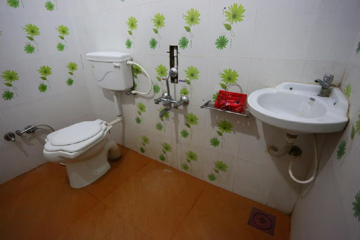 Well-maintained private washroom for Hotel Somnath Sagar's double room, equipped with essential toiletries and hot water.