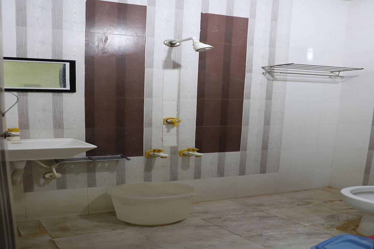Spotlessly clean washroom for Hotel Somnath Sagar's triple bed room in Veraval, featuring a modern shower area.