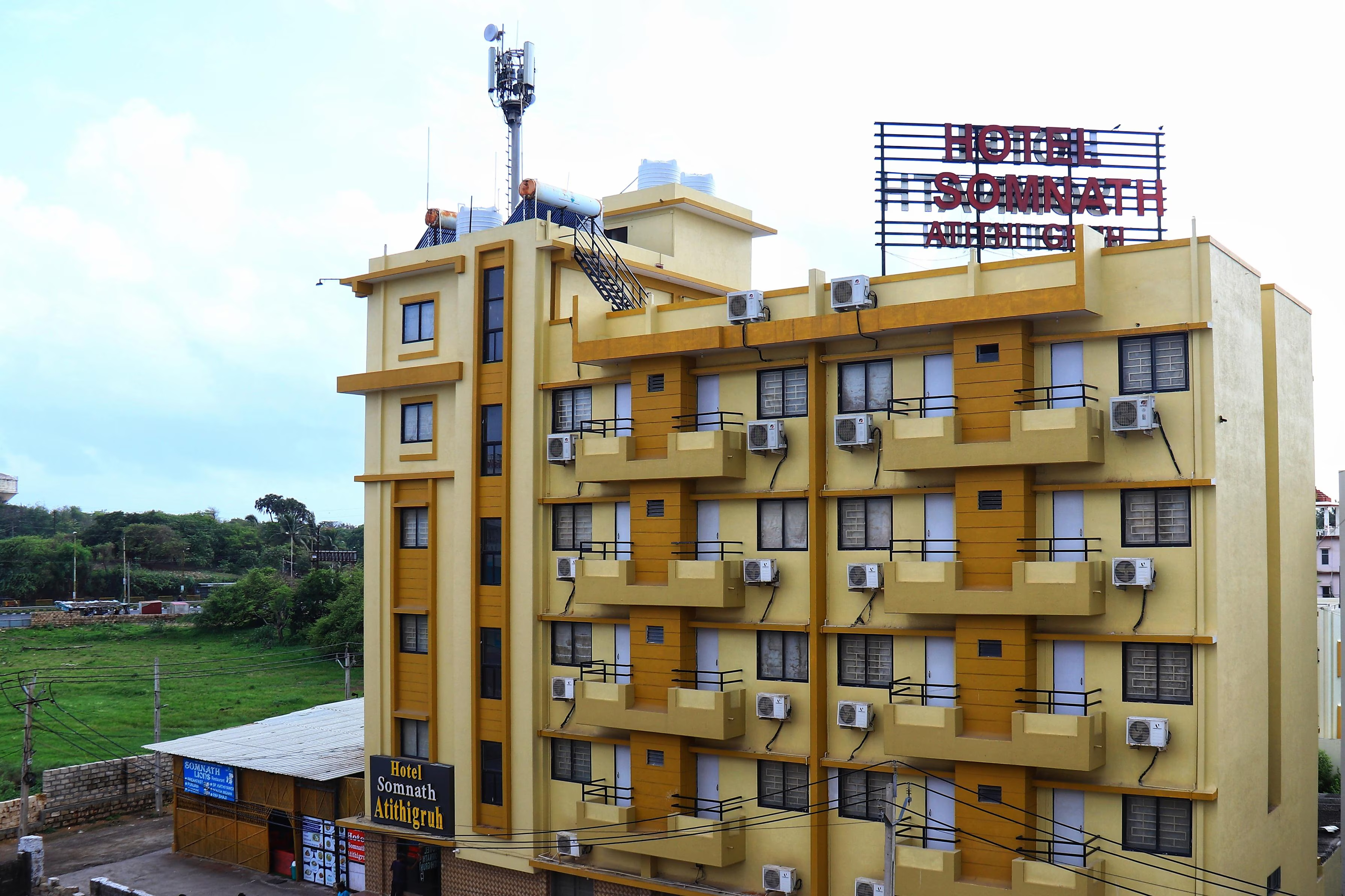 Side view of Hotel Somnath Atithigruh building, showcasing its modern architecture, ideal for pilgrims visiting Somnath.