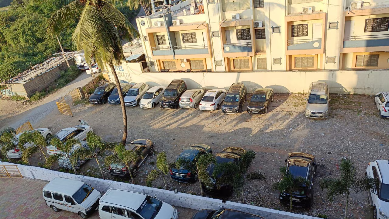 Secure and ample parking area at Hotel Somnath Atithigruh, offering convenient guest parking in Somnath.