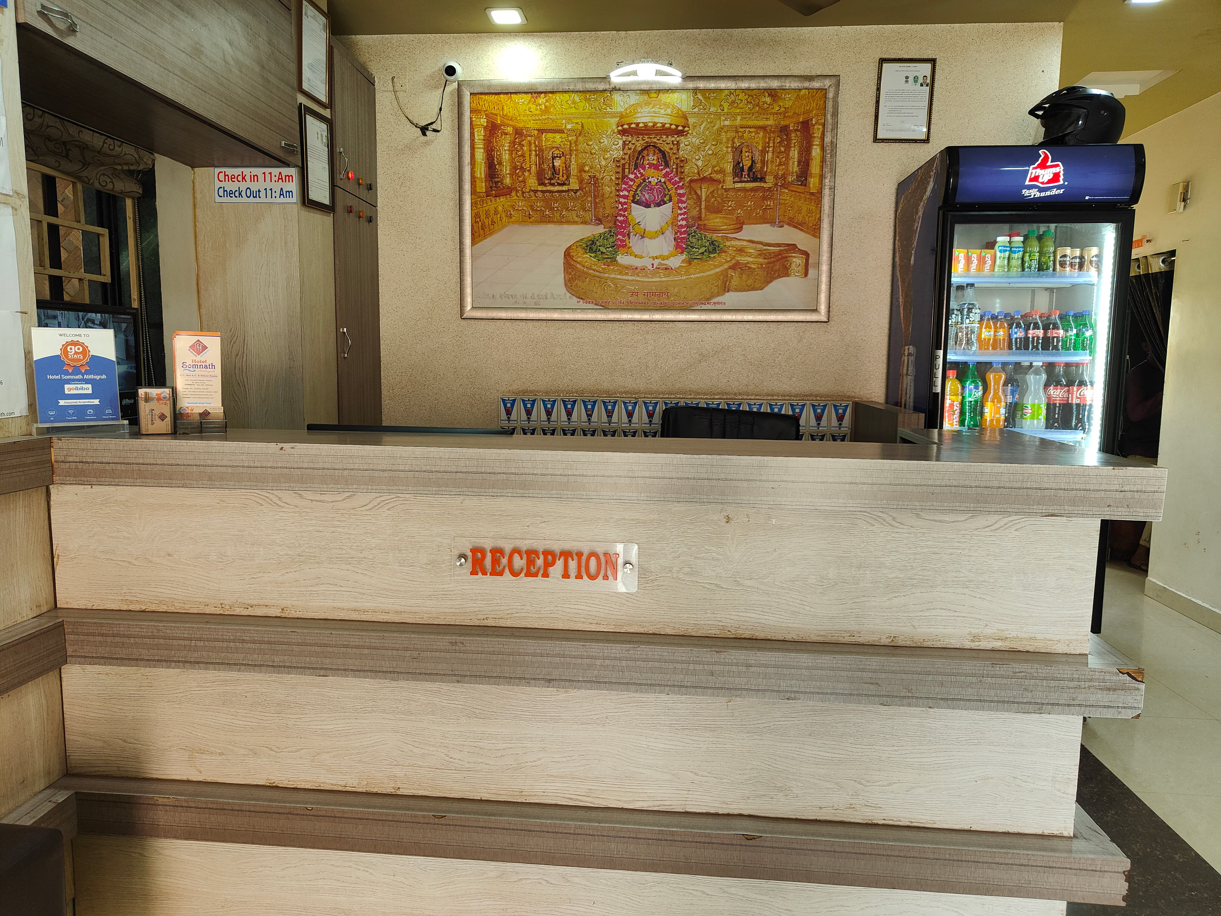 Modern reception desk and comfortable guest sitting area at Hotel Somnath Atithigruh, ensuring a smooth check-in.